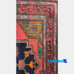 Corner detail of Turkmen Handwoven Area Rug Red Hand wash only binding and edges