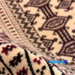Corner detail of Turkmen Handwoven Carpet Red Design Hand wash binding and edges