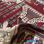 Corner detail of Baloch Handwoven Carpet Red Can be washed by hand or in a dishwasher. binding and edges