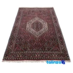 Corner detail of Persia Handwoven Rug Traditional Design Red binding and edges