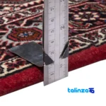 Edge view of Persia Handwoven Rug Red Design border and finishing