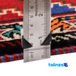 Corner detail of Si Persia Handwoven Rug Red binding and edges