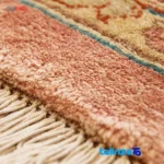 Corner detail of Handwoven Carpet Geometric Design Peach binding and edges