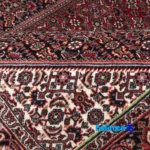In-room view of C Persia Handwoven Carpet Red room styling and scale