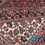 In-room view of Cypress Persian Handwoven Rug Red room styling and scale